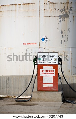 gas pump in front of storage tank in an old part of town, small-town USA