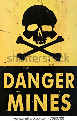 danger mines - old sign warning of land mines or minefield, closeup