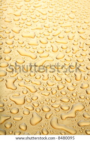 water drops golden background, abstract closeup with focus point roughly 1/4 from bottom