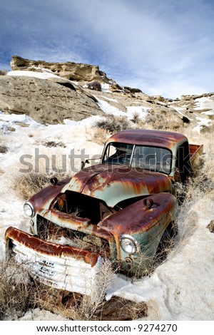 stock photo abandoned vintage car rusting away in the snow