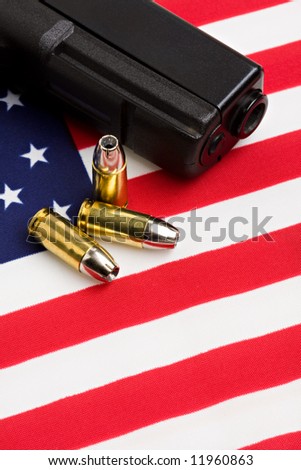 handgun and bullets closeup on American flag
