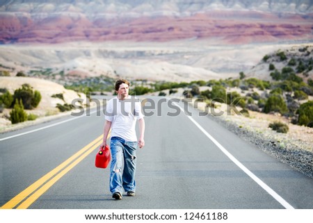 teenager out of gas, walking down rural mountain road with gas can
