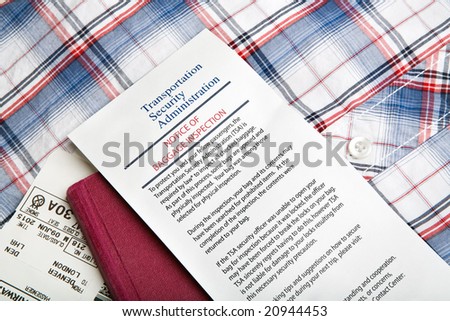 airport security - baggage inspection with notice card