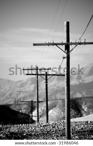 power lines utility poles running through hills of rural California
