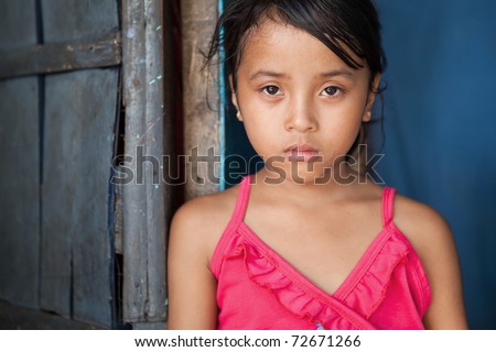 stock photo Portrait of a young girl from povertystricken area in Manila