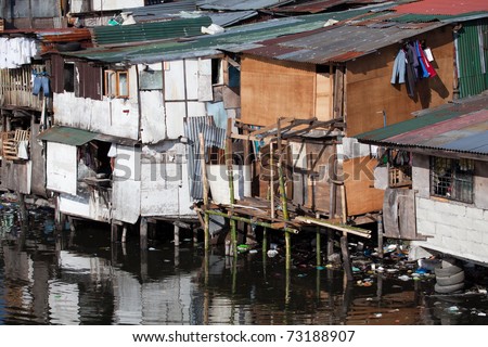 Squatter homes in the Philippines - shacks in shanty town along heavily polluted Paranaque river in Manila.