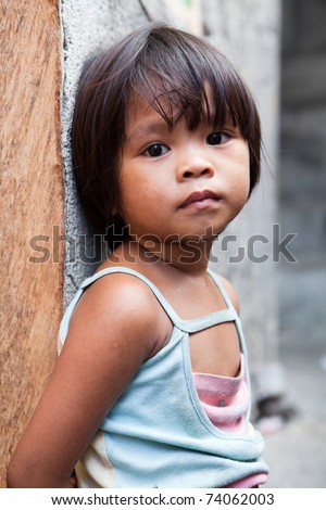stock photo Adorable young girl in the Philippines living in poverty