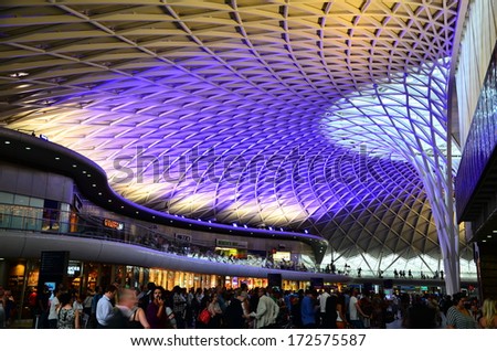 London - 12 July 2013 : The Ceiling Of King\'S Cross Railway Station New Concourse Illuminated Diagrid Roof Structure. This Is A New Part Of The Station Which Has A Plethora Of Travelers Everyday.