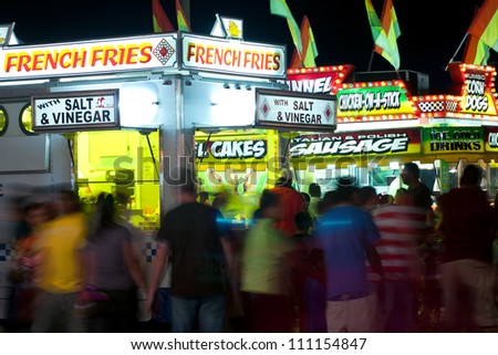 LAWRENCEVILE, GA, USA - SEPTEMBER 24:  Unidentified patrons walk amongst a variety of fast food vendors at the Gwinnett County Fair in Lawrenceville on September 24, 2011