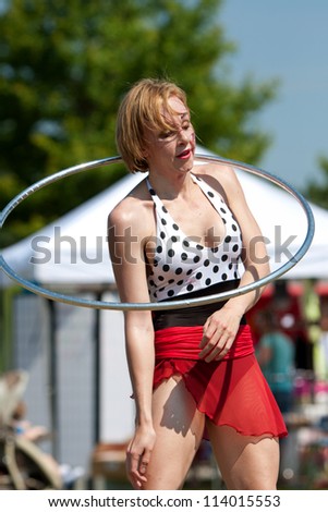 SUWANEE, GA - MAY 19:  A female circus performer does the hula hoop, performing at the Arts In The Park festival on May 19, 2012 in Suwanee, GA.  She performs for The Imperial OPA Circus.