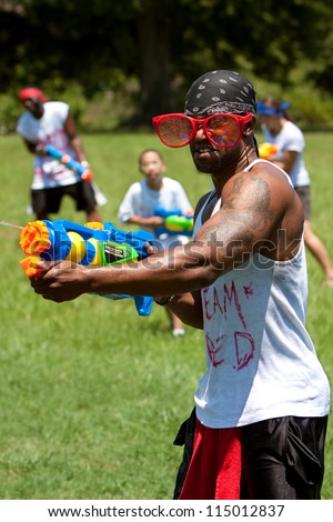 ATLANTA, GA - JULY 28:  Unidentified people take part in a water gun battle called the Fight4Atlanta, a squirt gun fight between dozens of locals at Freedom Park on July 28, 2012 in Atlanta.