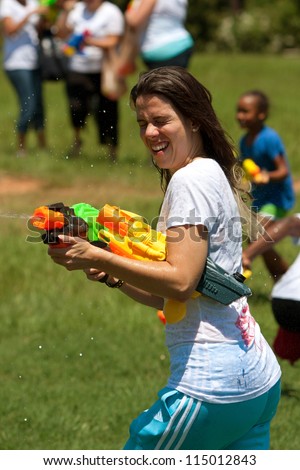 ATLANTA, GA - JULY 28:  An unidentified woman takes part in a squirt gun battle called the Fight4Atlanta, a water gun fight between local residents at Freedom Park on July 28, 2012 in Atlanta.