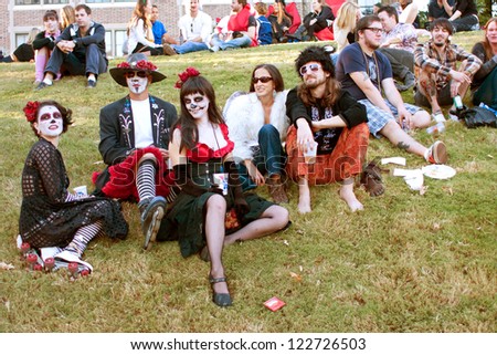ATLANTA, GA - OCTOBER 20:  Several people dressed as hippie zombies relax and drink beer after walking in the Little Five Points Halloween parade on October 20, 2012 in Atlanta.