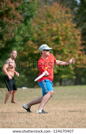 ATLANTA, GA - OCTOBER 27:  An unidentified young male prepares to throw a frisbee during an Ultimate Frisbee game between two teams in Piedmont Park on October 27, 2012 in Atlanta.