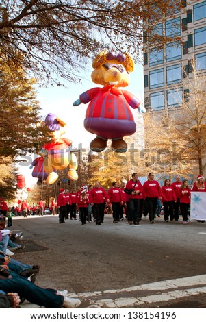 ATLANTA, GA - DECEMBER 1:  Large inflated balloon characters and volunteers move through the parade route at the annual Atlanta Christmas parade on December 1, 2012 in Atlanta, GA.