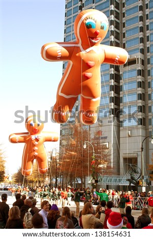 ATLANTA, GA - DECEMBER 1:  Two inflated gingerbread man balloons move through the parade route at the annual Atlanta Christmas parade on December 1, 2012 in Atlanta, GA.