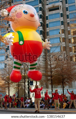 ATLANTA, GA - DECEMBER 1:  Workers use ropes to guide a huge float along the parade route in the annual Atlanta Christmas parade on December 1, 2012 in  Atlanta, GA.