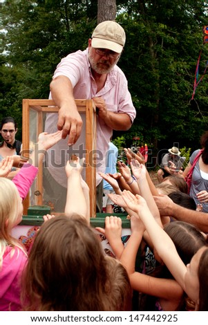 ROSWELL, GA - JULY 13:  An unidentified man releases butterflies from a box, at the Chattahoochee Nature Center\'s Butterfly Festival on July 13, 2013 in Roswell, GA.