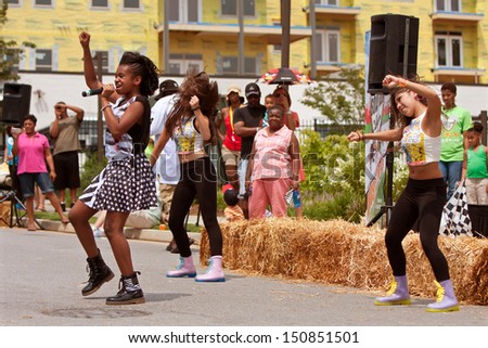 ATLANTA, GA - AUGUST 3: Teen singer Aleacea and dancers perform at the Cool Dads Rock Soap Box Derby, at the Old 4th Ward Park on August 3, 2013 in Atlanta.
