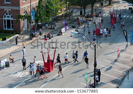 ATHENS, GA - AUGUST 24:  Several men compete in a 3-on-3 basketball tournament held on the streets of downtown Athens, on August 24, 2013 in Athens, GA.