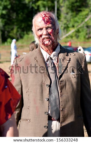 DALTON, GA - SEPTEMBER 14:  A bloody elderly male zombie gets ready to take the field to menace runners in the Run For Your Lives 5K event, on September 14, 2013 in Dalton, GA.