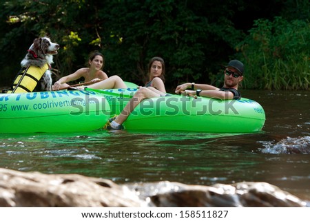 HELEN, GA - AUGUST 24:  People tube down the Chattahoochee River in North Georgia, with a dog wearing a life vest in its own tube, on August 24, 2013 in Helen, GA.  Hundreds went tubing on the river.
