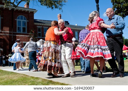 LAWRENCEVILLE, GA - OCTOBER 12:  Senior citizens square dance outdoors at the Old Fashioned Picnic and Bluegrass Festival on October 12, 2013 in Lawrenceville, GA. The event was free to the public.
