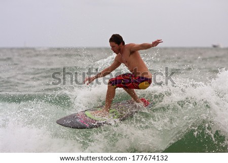FT. LAUDERDALE, FL - DECEMBER 29:  A young man surfs a wave near the Florida shoreline over the Christmas holiday break, on December 29, 2013 in Ft. Lauderdale, FL.