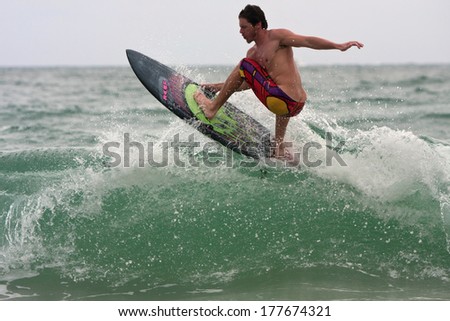 FT. LAUDERDALE, FL - DECEMBER 29:  A young male surfer rides a wave near the shoreline over the Christmas holiday break, on December 29, 2013 in Ft. Lauderdale, FL.