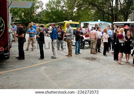 ATLANTA, GA - OCTOBER 16:  Customers stand in line to order meals from several food trucks during their lunch hour, at \