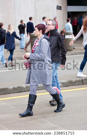 ATLANTA, GA - DECEMBER 6:  A female University of Alabama fan dressed head to toe in houndstooth, walks to the Georgia Dome to watch the SEC Championship game on December 6, 2014 in Atlanta, GA.