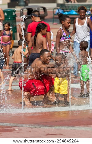 ATLANTA, GA - SEPTEMBER 6:  Families and kids gets soaking wet while playing in the fountain at Centennial Park on September 6, 2014 in Atlanta, GA.