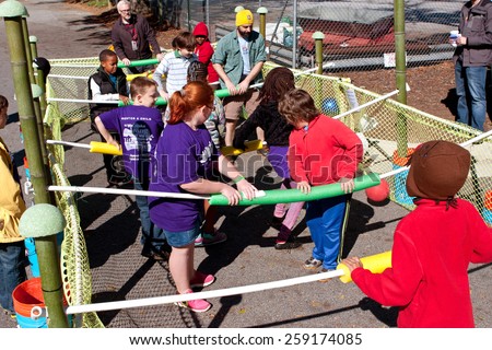 DECATUR, GA - OCTOBER 4:  Kids and adults play a game of human foosball at the annual Maker Faire Atlanta, on October 4, 2014 in Decatur, GA.