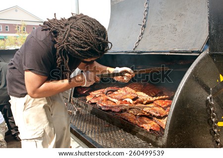 LAWRENCEVILLE, GA - OCTOBER 11:  A restaurant cook grills slabs of ribs in an industrial grill as part of the Rock \'N Ribville Barbecue Festival on October 11, 2014 in Lawrenceville, GA.