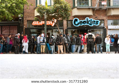 SAN FRANCISCO, CA - MAY 15:  A long line of people waits to get into a new Cookies store on May 15, 2015 in San Francisco.  Cookies sells clothes and marijuana-related swag and accessories.