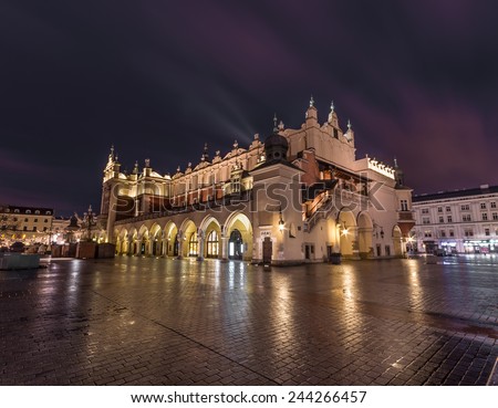 Krakow, Poland, Krakow, Poland, view of Sukiennice, Cloth-hall, medieval shopping mall in the heart of the old city, illuminated in the darkness.