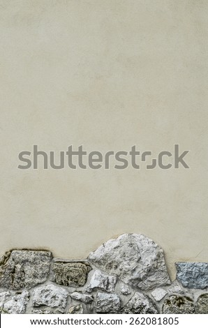Plastered wall with a stone foundation