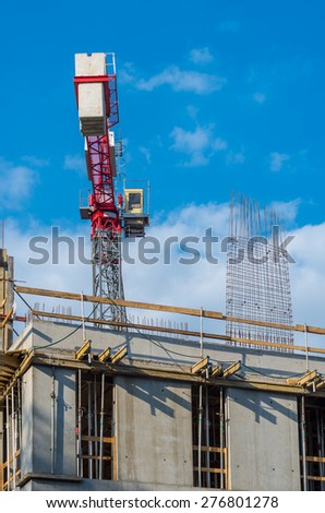 Concrete formwork, reinforcing bars and crane on the office building construction site