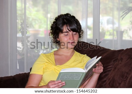 The Young Woman Reading Foreign Book inside