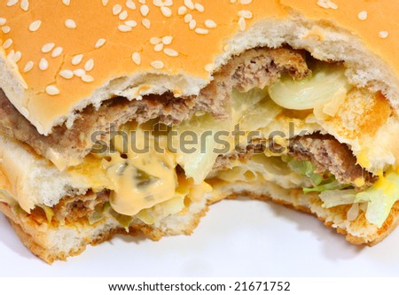 Big burger isolated on white with bites