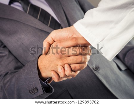 Businessman and doctor shaking hand\'s.