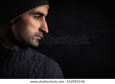 Profile of handsome man on a dark background