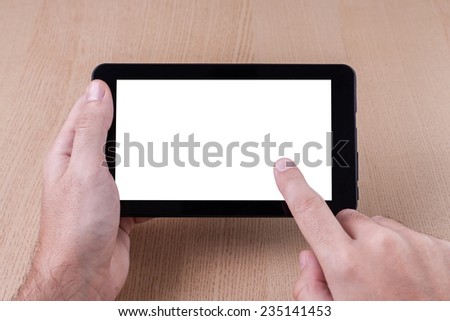 Working on tablet PC, finger touching screen.