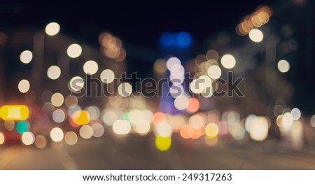 Blurred background. Night city lights blur. Retro toned photo, vintage.
