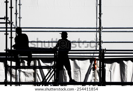 Silhouette of a workers on a construction site.