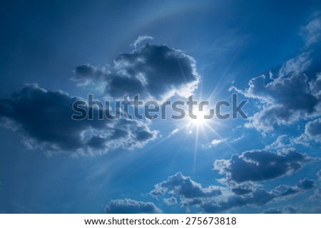 Sun\'s rays in the sky and clouds with highlights and rainbow halo