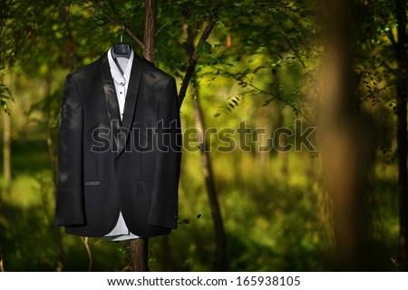 Groom tuxedo hanged in a tree, nature