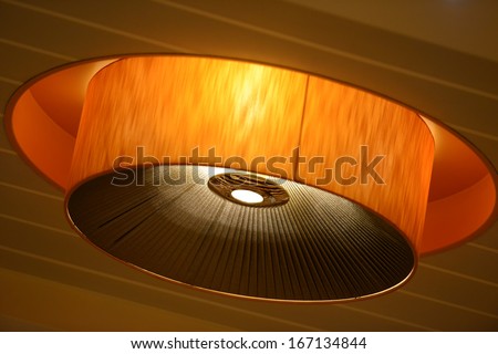 One lamp on the ceiling isolated on wooden texture
