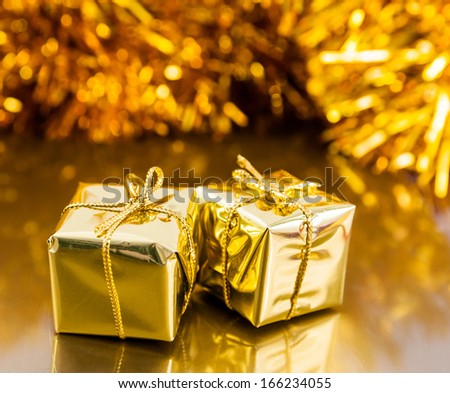 Golden boxes with christmas gifts on golden background