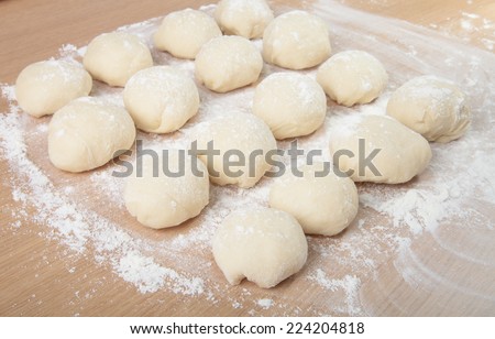 Small balls of dough with flour for pizza or cakes and scones. Shallow depth of field